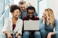 Smiling multicultural students with laptop in university Royalty Free Stock Photo