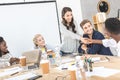 smiling multiethnic business partners shaking hands during conference with multicultural colleagues Royalty Free Stock Photo