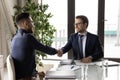 Smiling multiethnic businessmen handshake at meeting in office Royalty Free Stock Photo