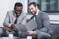 smiling multiethnic businessmen reading document Royalty Free Stock Photo