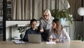 Smiling diverse female colleagues brainstorm at laptop Royalty Free Stock Photo