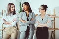 smiling multiethnic businesswomen in formal wear standing