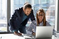 Smiling multiethnic colleagues work on laptop together Royalty Free Stock Photo