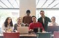 Smiling multiethnic coworkers looking at camera making team picture in modern office together - Happy diverse work group or Royalty Free Stock Photo