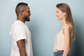 Smiling multiethnic man and woman in profile look in eyes Royalty Free Stock Photo