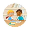 Smiling multiracial boys reading books and talking to each other at school library. School kids discussing literature in Royalty Free Stock Photo