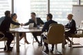 Smiling multiracial business people sitting at meeting