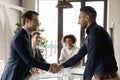 Smiling multiracial businessmen handshake at meeting in office Royalty Free Stock Photo