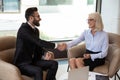 Smiling multiracial colleagues handshake closing deal at meeting Royalty Free Stock Photo