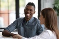 Smiling multiracial colleagues have fun cooperating at meeting Royalty Free Stock Photo