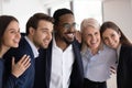 Smiling multiracial colleagues posing for group picture in office Royalty Free Stock Photo