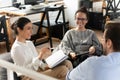 Smiling multiracial colleagues take part in teambuilding in office