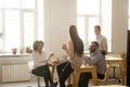 Smiling multiracial colleagues talking while eating pizza at off Royalty Free Stock Photo