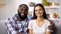 Smiling multiracial couple hugging and looking to camera, social insurance Royalty Free Stock Photo