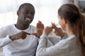 Smiling multiracial friends talk using sign language Royalty Free Stock Photo