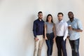 Smiling multiracial group of international company workers standing in line. Royalty Free Stock Photo