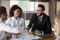 Smiling male colleagues handshake greeting at office briefing Royalty Free Stock Photo