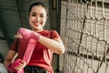 smiling muscled asian woman fighter wearing red strap on wrist