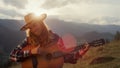 Smiling music player perform song on guitar close up. Woman play in mountains. Royalty Free Stock Photo