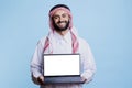 Muslim advertiser holding laptop