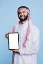 Muslim man showing tablet empty screen