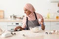 Muslim Woman Checking Online Recipe On Digital Tablet While Baking In Kitchen Royalty Free Stock Photo