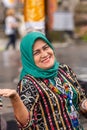 Smiling Muslim woman at Ulun Danu Beratan Temple complex, Bedoegoel, Bali Indonesia