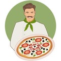 Smiling mustachioed cook with a bandana around his neck carrying a caprese pizza