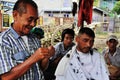 Smiling myanmar barber at work