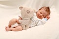 Smiling Newborn Baby Boy Sleeping with Teddy bear