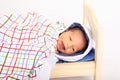 Smiling newborn baby boy in small wooden bed Royalty Free Stock Photo