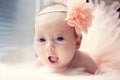 Smiling newborn baby girl with a flower in her hair Royalty Free Stock Photo