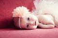 Smiling newborn baby girl with a flower in her hair Royalty Free Stock Photo