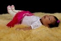 Smiling newborn Baby girl on a plush fur rug Royalty Free Stock Photo