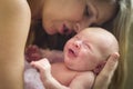 Smiling Newborn Baby and her Young Beautiful Mother Royalty Free Stock Photo