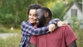 Smiling newly married couple celebrate buying new cottage in countryside