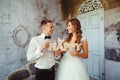 Smiling newlyweds hold wooden lettering HAPPY