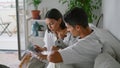 Smiling newlyweds speaking couch together closeup. Caring man pouring coffee cup