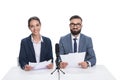 smiling newscasters with papers and microphone looking at camera, Royalty Free Stock Photo