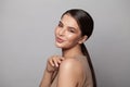 Smiling nice mixed race woman with perfect skin and long dark hair studio portrait