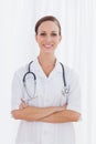 Smiling nurse with arms crossed looking at camera Royalty Free Stock Photo