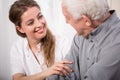 Smiling nurse assisting senior man Royalty Free Stock Photo