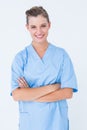 Smiling nurse in blue scrubs posing with arms crossed Royalty Free Stock Photo