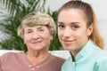 Smiling nurse with an elderly lady Royalty Free Stock Photo