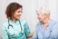 Smiling nurse and happy elderly lady Royalty Free Stock Photo