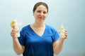 Smiling nurse is holding breast pump, bottle of milk. mixed feeding, preserving lactation of working mom. Help with breastfeeding,