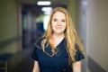 Smiling nurse in hospital hallway