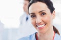 Smiling nurse looking at camera with a doctor behind her Royalty Free Stock Photo