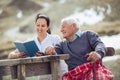 Smiling nurse reading book to senior man Royalty Free Stock Photo