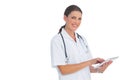 Smiling nurse using her tablet Royalty Free Stock Photo